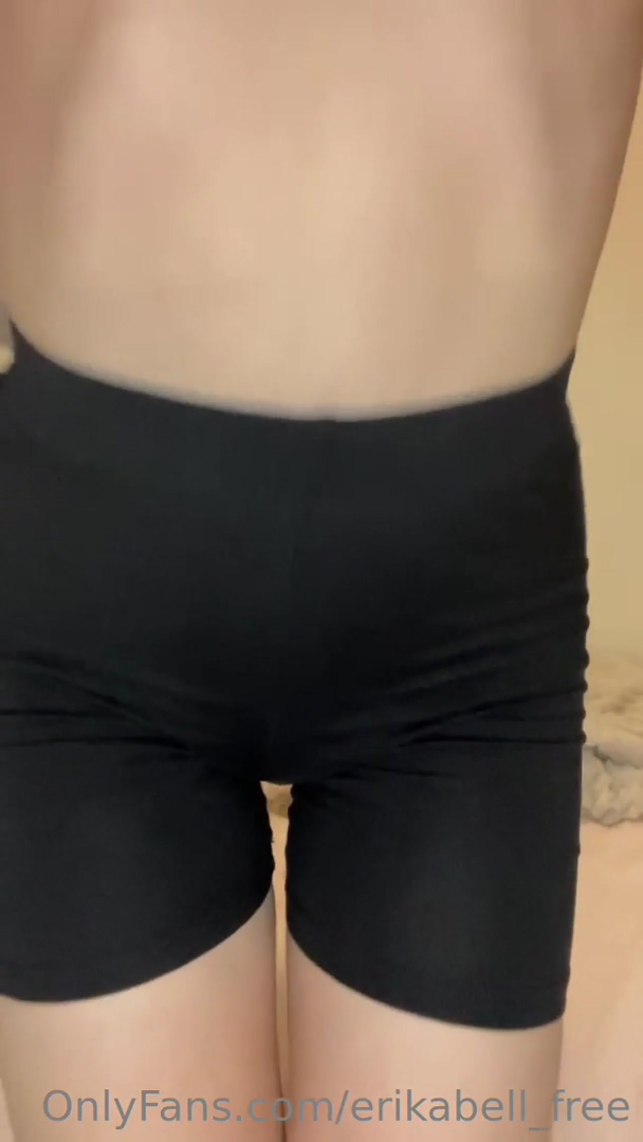 Brunette pulls down shorts slowly